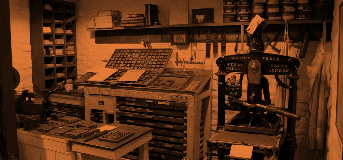 A print shop with an Albion hand press and cases of metal type